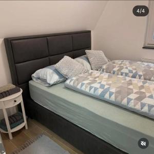 ein Schlafzimmer mit einem Bett mit Kopfteil und Kissen in der Unterkunft Blidinje S7 - Risovac -280 m staza in Jablanica