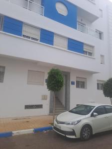 a white car parked in front of a building at HALA Chaouni in Tétouan