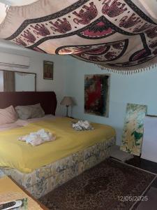 a bedroom with a bed with towels on it at Cozy Room with Queensize bed in Historic House in Senglea