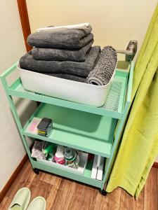a stack of towels on a shelf in a room at サイプレス平岸 in Sapporo +41 photos