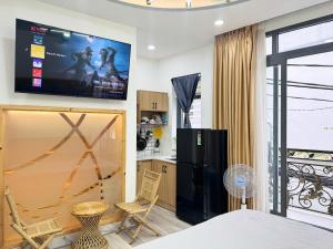 a living room with a flat screen tv on the wall at Four P Home in Ho Chi Minh City