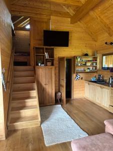 a room with a staircase in a wooden cabin at Roubenka in Železná Ruda