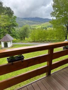 a wooden deck with a view of a gazebo at Roubenka in Železná Ruda