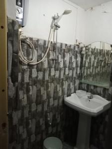 a bathroom with a sink and a shower curtain at Galle Paradise Inn in Galle