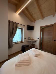 Ένα ή περισσότερα κρεβάτια σε δωμάτιο στο Cusìcla Affittacamere