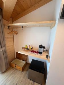 a room with a desk in a tiny house at Cusìcla Affittacamere in Ponte di Legno
