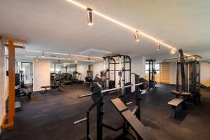 a gym with several treadmills and weights at Sais Beach Living Hotel in Maceió