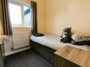 a bedroom with a bed with a backpack on it at Raven Lodge in Brigg