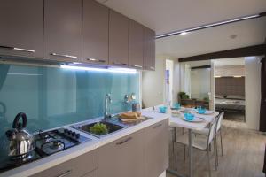 a kitchen with a sink and a counter top at Isola dei Gabbiani - Land of water in Porto Pollo