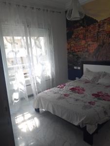 a bedroom with a bed and a window at Appartement les jardins de Carthage in Carthage