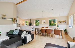 a living room and kitchen with a couch and a table at Gorgeous Home In Farsø With Wifi in Hole