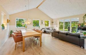 a living room with a table and a couch at Gorgeous Home In Farsø With Wifi in Hole