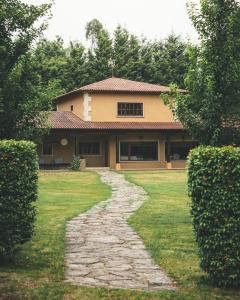 a house with a stone path in front of it at HolaCamp Camino Apartamentos Turísticos in O Pino  +46 photos