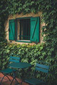 two chairs and a table in front of a window at HolaCamp Camino Apartamentos Turísticos in O Pino 