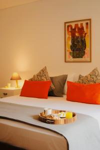 a hotel room with a bed with a tray of food on it at Apto con terraza privada junto al Bulevar del Rio y Calle del Sabor in Cali