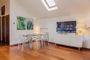 a dining room with a table and some chairs at Il camino felice - 201 by Houset in Monza