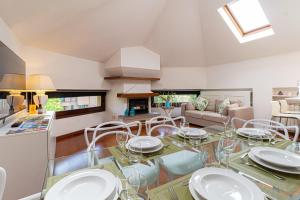 a kitchen and living room with a glass table and chairs at Il camino felice - 201 by Houset in Monza