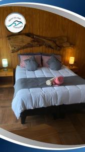 a bedroom with a bed with a hat on it at Suite Matrimonial 2 Rocas del Mar in Pichilemu