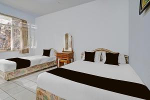 Postel nebo postele na pokoji v ubytování OYO 94802 Hotel Prima