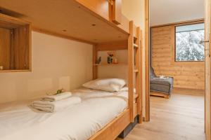a bedroom with bunk beds in a log cabin at Chamonix Sud - Grepon 102 - Happy Rentals in Chamonix-Mont-Blanc