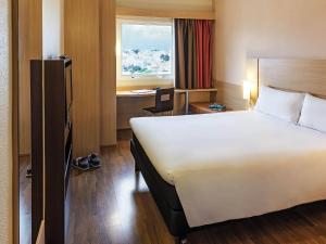 pokój hotelowy z łóżkiem, biurkiem i oknem w obiekcie ibis Sao Paulo Interlagos w São Paulo