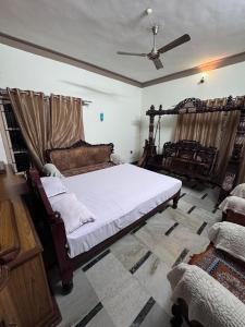 a bedroom with a large bed and a ceiling at Rooms in appartment by LUXE in Mysore