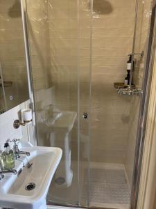 a bathroom with a shower and a sink at The Brontë Birthplace in Thornton +51 photos