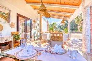 a dining room with a table with plates and glasses at Finca Can Puput Bó in Son Gual