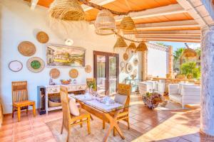 a living room with a table and chairs at Finca Can Puput Bó in Son Gual +15 photos