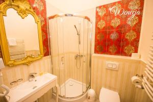 a bathroom with a shower and a toilet and a sink at Sempre B&B in Płock