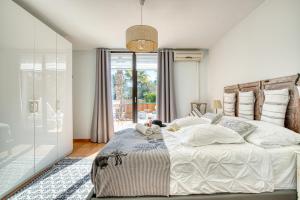 a bedroom with a bed and a glass door at Finca Can Puput Bó in Son Gual