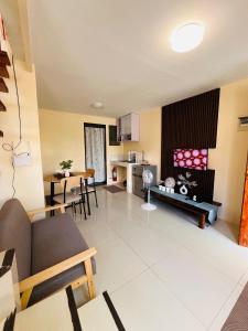 a living room with a couch and a table at JOs HOMEtel at Heritage City of the South Carcar in Guinauayan