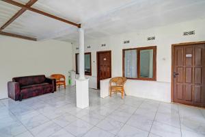 ein Wohnzimmer mit Couch und Stühlen in der Unterkunft Collection O Subang near Ciater Subang formerly Orchid Villa Ciater in Ciater