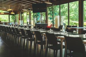 a row of tables and chairs in a restaurant at HolaCamp Aran Aventura in Les