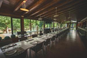 a long row of tables and chairs in a restaurant at HolaCamp Aran Aventura in Les