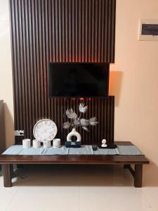 a coffee table with a clock and a clock at JOs HOMEtel at Heritage City of the South Carcar in Guinauayan