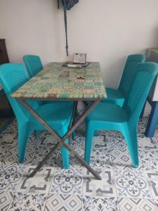 a table with four chairs and a laptop on it at BALLESTRINQUE - GETSEMANI- CARTAGENA DIVINa in Cartagena de Indias