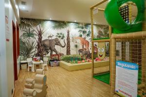 a childrens play room with a mural of animals at Hotel Reśliński in Grodzisk Wielkopolski