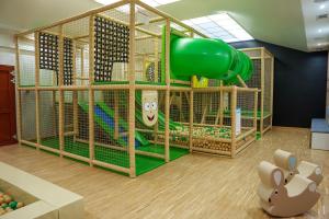 a play room with a playground with a slide at Hotel Reśliński in Grodzisk Wielkopolski