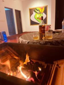 a bottle of beer sitting next to a fire pit at MARARI CASA LINDA HOMESTAY in Mararikulam