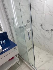 una ducha con puerta de cristal en un baño en Orbi city d block, en Batumi