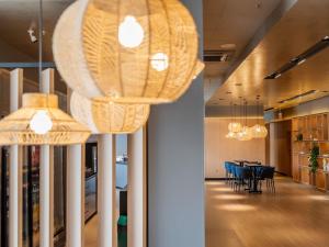a dining room with two chandeliers and a table at ibis Navegantes Itajai in Itajaí