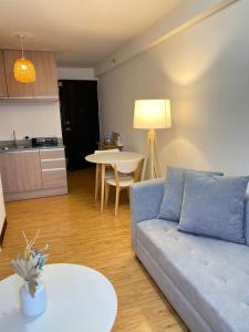 a living room with a couch and a table at EasyStay Condo Davao in Davao City