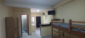 a bedroom with a bunk bed and a bathroom at Hospedaje San Cosme y Damián in Zarate Isla