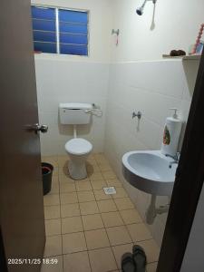 a bathroom with a toilet and a sink at Homestay No 68 Raub in Raub +12 photos