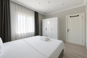 Ένα ή περισσότερα κρεβάτια σε δωμάτιο στο Casa Florya Suites