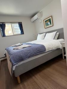 En eller flere senge i et værelse på Myoko Station House