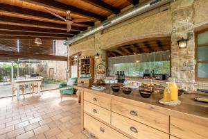 a kitchen with a large island in a room at Hotel Mas la Ferreria in La Vall de Bianya