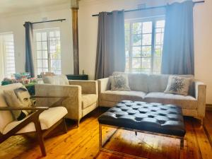 a living room with couches and a coffee table at The White House in George