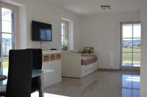a living room with a tv and a couch at Ferienhaus zur Tulpe, Legoland in Ettenbeuren